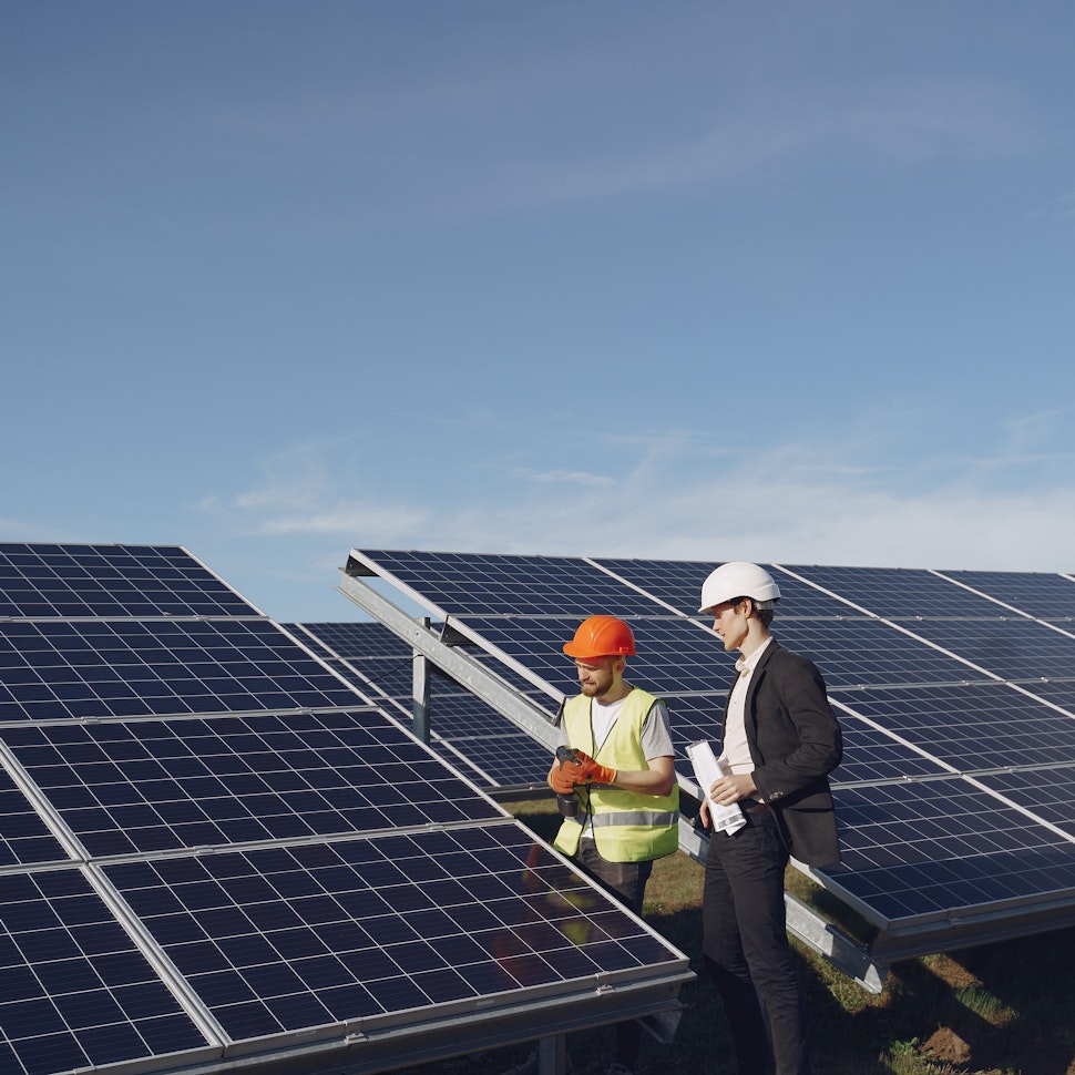 Man in suit and engineer in solar farm