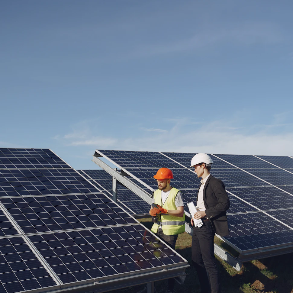 Man in suit and engineer in solar farm