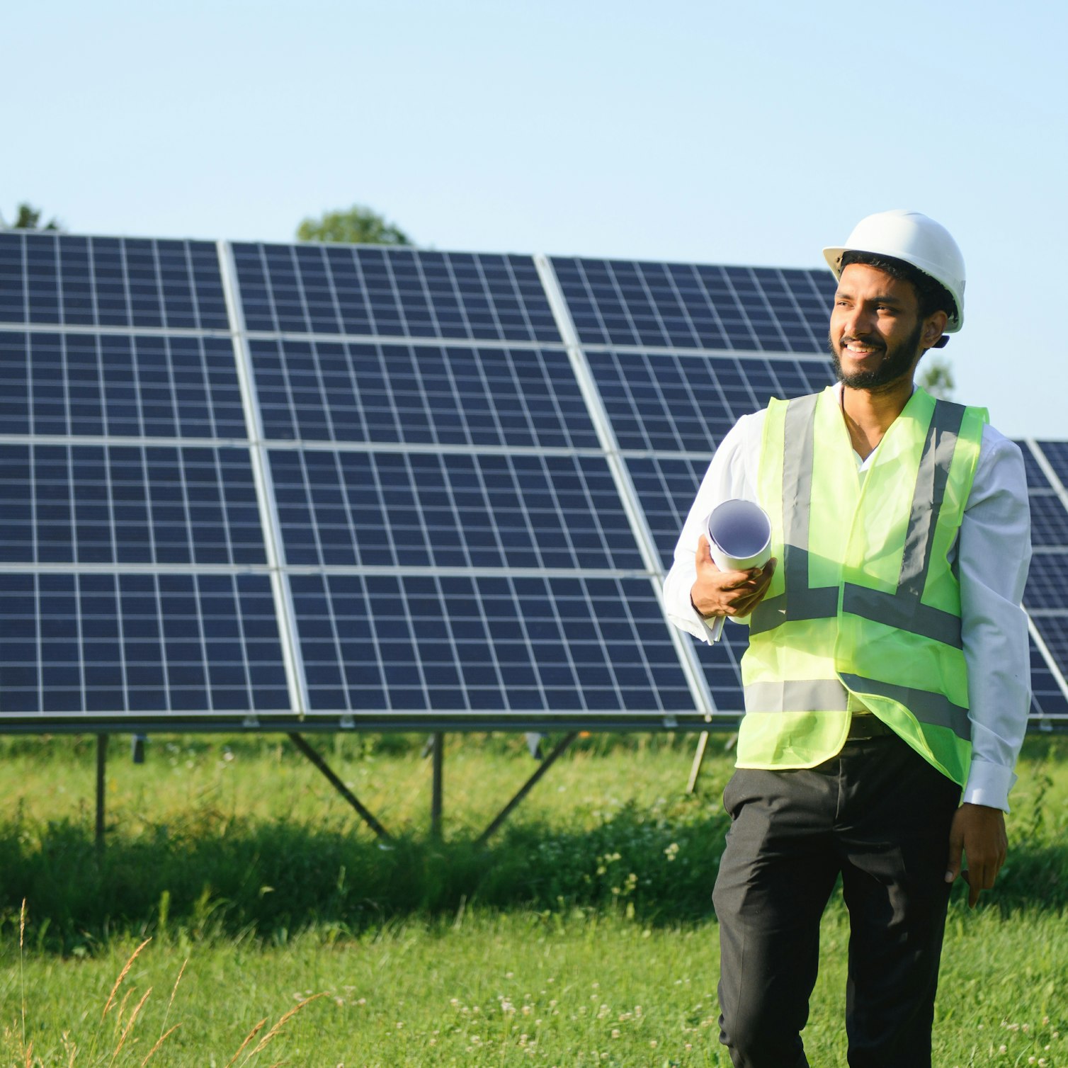 Man in front of solar panels