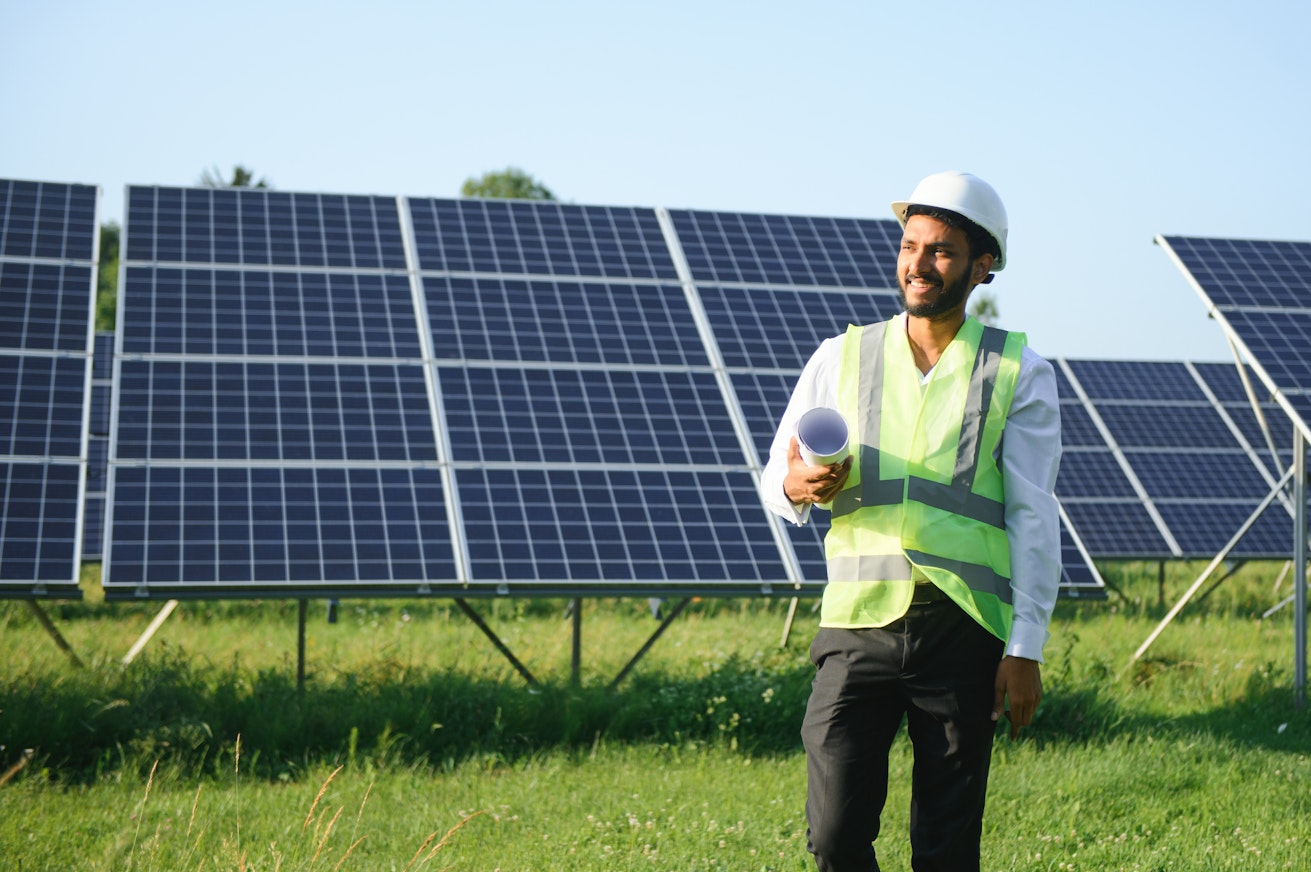 Man in front of solar panels